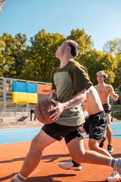 stock image Lviv, Ukraine - May 12, 2022: men playing basketball outdoors copy space