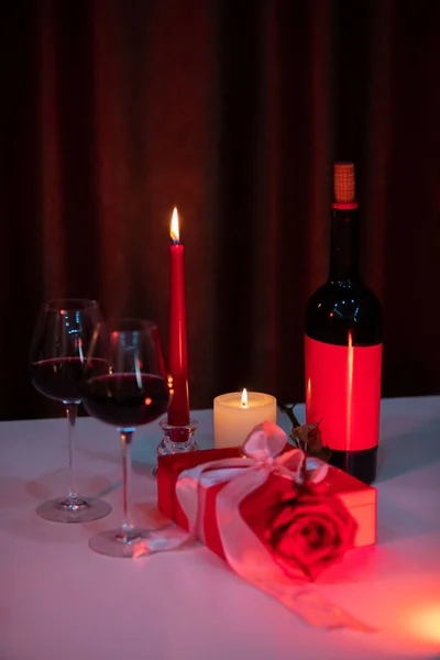romantic date concept red wine with glasses and candles gift box