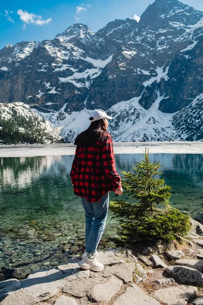 stock image A woman is standing on the shore of a lake. Morskie Oko, Tatras mountains. Poland