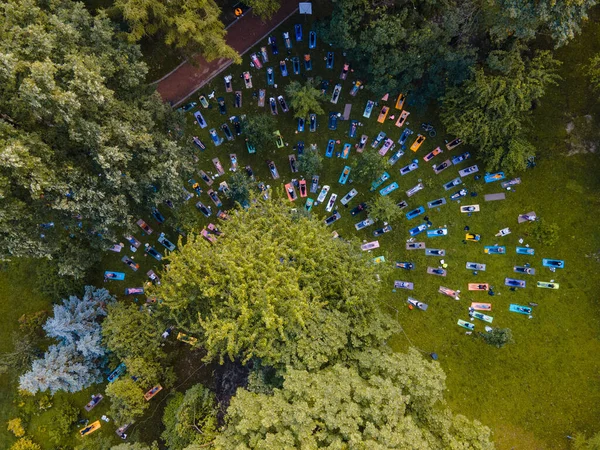 overhead view of people do yoga at city public park