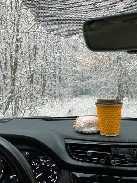 Burgers and coffee are on dashboard