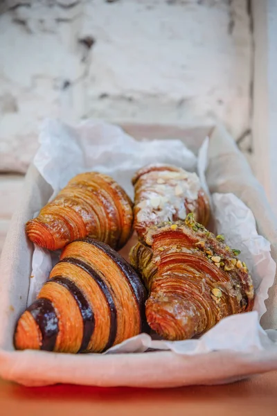 stock image four types of croissants in basket on white table