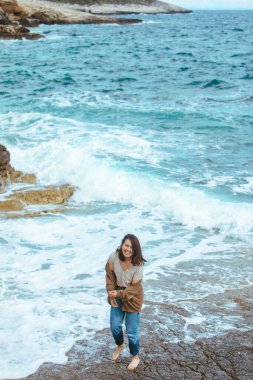 ıslak kot yalınayak kayalık plaj da yürüyüş kadın. yaz deniz tatili