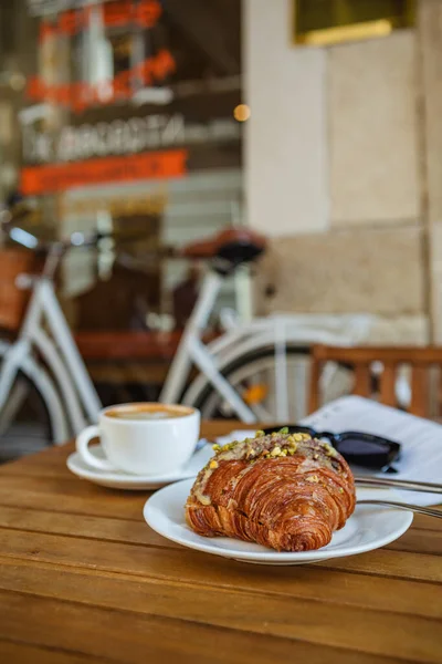 stock image Breakfast time with croissant, coffee, and magazine