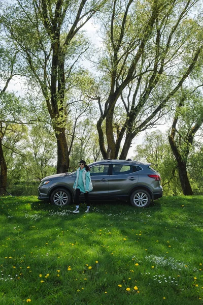 Μια Γυναίκα Απομακρύνεται Από Ένα Παρκαρισμένο Αυτοκίνητο Ένα Καταπράσινο Γρασίδι — Φωτογραφία Αρχείου