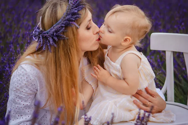 Mom Purple Wreath Kisses Her Daughter Who Sitting White Chair — Stock Photo, Image