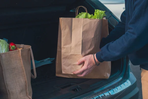 Man Hands Groceries Bags Put Car Trunk Close — Stock Photo, Image