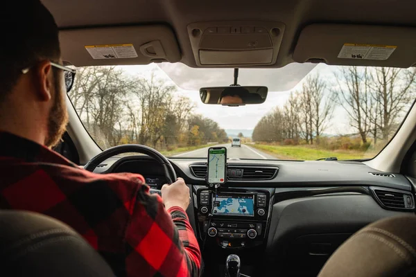 Stock image road trip concept man driving car by highway inside view autumn season