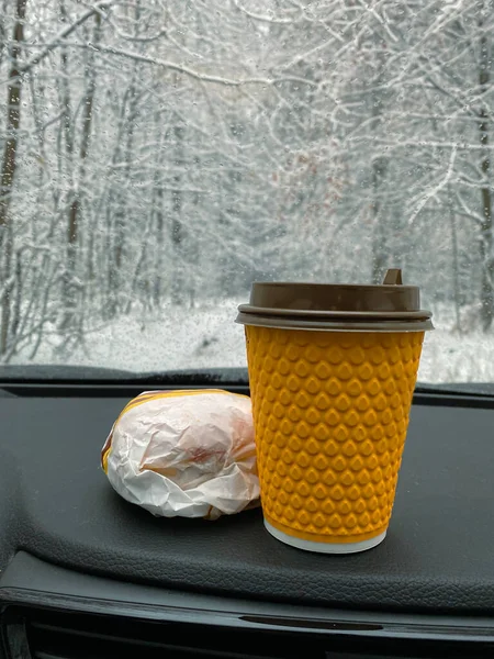 dashboard of car has hamburgers and coffee