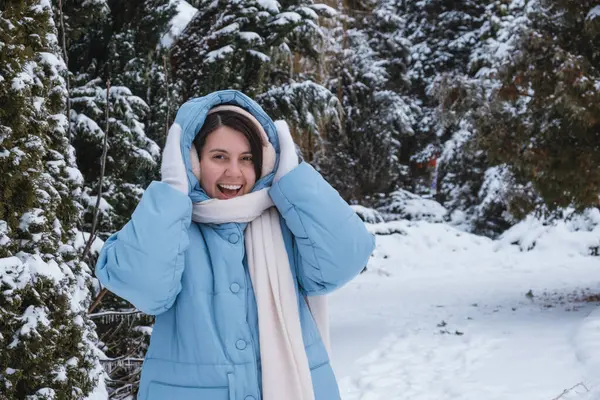 portrait of happy beautiful woman outside at cold winter day snowy outfit