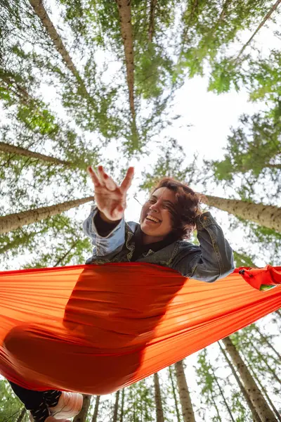 happy woman on hammock in the forest hiking concept