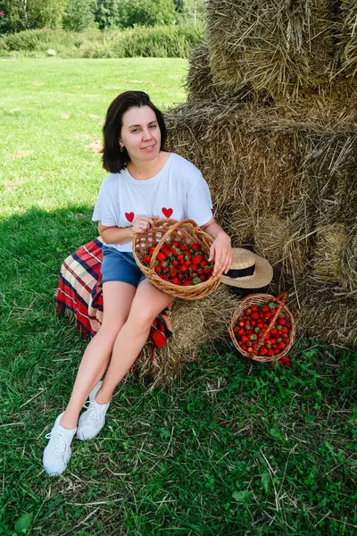 Portrait of Smiling Woman with Basket of Strawberries copy space