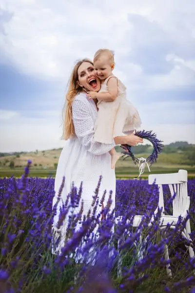 Happy Mother Hugs Her Daughter Smiles While Standing White Chair — Stock Photo, Image