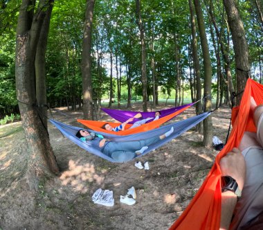 friends Relaxing in Colorful Hammocks in the Forest copy space clipart