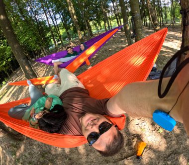 friends Relaxing in Colorful Hammocks in the Forest copy space clipart