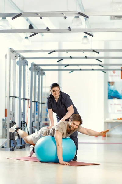 Physical rehabilitation, back strengthening, doing exercises, Health-improving exercises. Concept of physical therapy for enhancing back strength. Therapeutic strategies for injury recovery. Injury