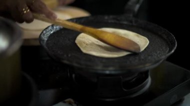 Ev mutfağında sıcak roti pişiriyorum.