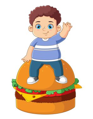 Koca bir hamburgeri olan tatlı bir çocuk.
