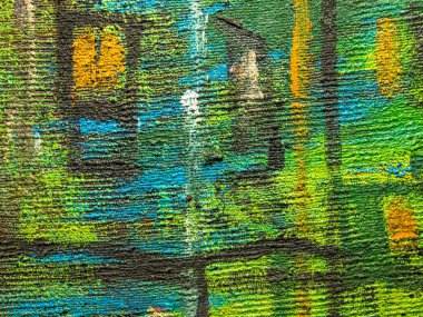 Resmin renkli yüzeyi. Resmin dokusu. Resim fraktürü boyama. Renkli doku. Soyut arkaplan. Yeşil, sarı, kahverengi ve mavi renklerle yağlı boya..