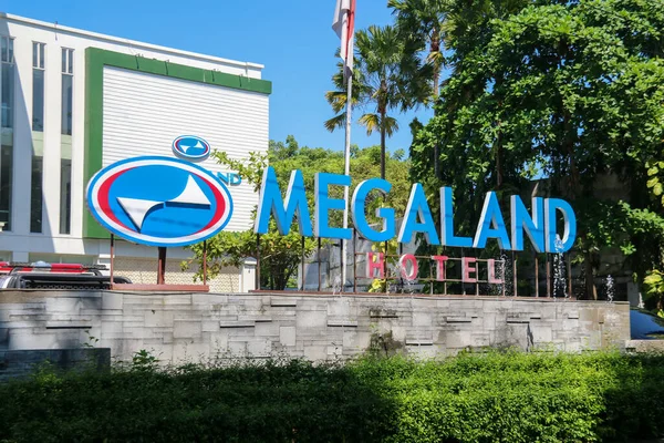 stock image Surakarta, Indonesia - May 16, 2023: Sign of Megaland hotel, modern hotel at Solo city. The blue and red sign reads 