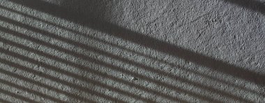 Düşük kontrastlı nötr arkaplan. Gri soyut taş doku arka planı. Arkaplan için alçı dokusu