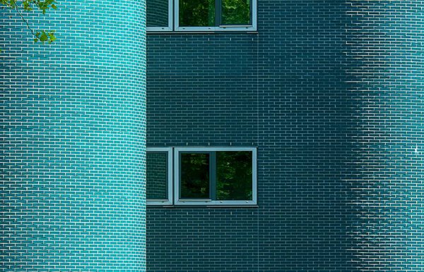 Green brick wall background with windows