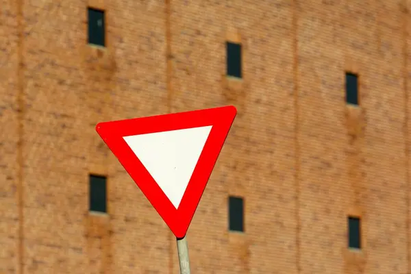 triangle sign with a red traffic sign