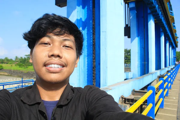 Sorrindo Jovem Asiático Homem Desgaste Preto Jaqueta Tomar Selfie Foto — Fotografia de Stock