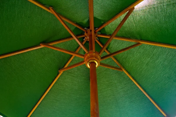 stock image green canvas and wood frame of inside umbrella for rain and sun protection