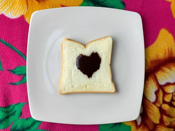 bread with black heart toping on white plate romantic concept of dinner in valentines day