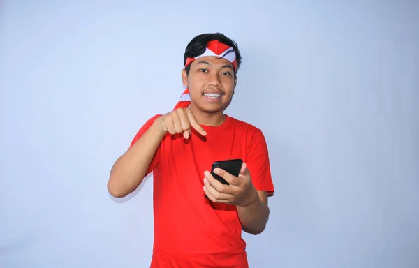 Glimlachende Indonesische Jongeman Wijzend Naar Zijn Mobiele Telefoon Met Vrolijk — Stockfoto