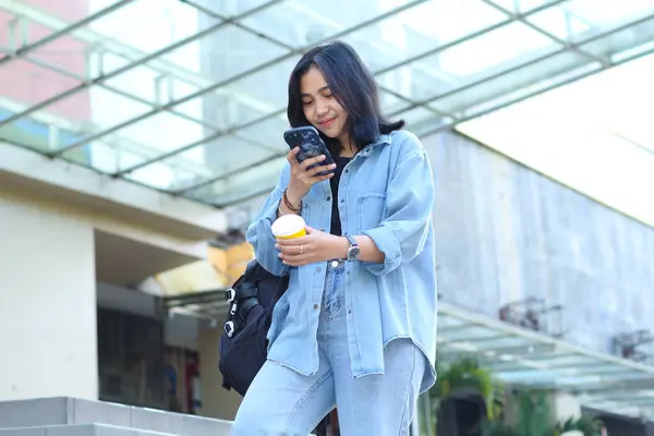 attractive beautiful asian young woman influencer enjoy recording video or vlogging or take a photo of a cup of coffee for small business social media content