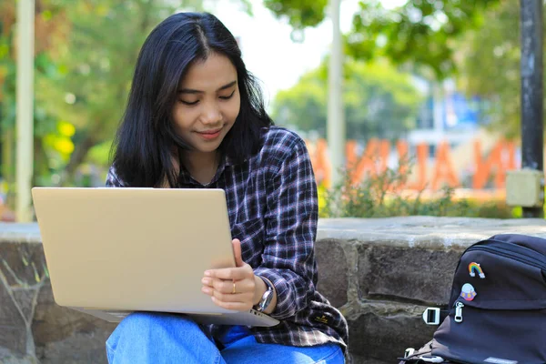 relax asian young woman smiling using laptop working freelance and happy get e commerce offer