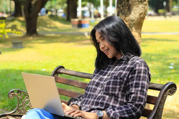 relax asian young woman smiling using laptop working freelance and happy get e commerce offer