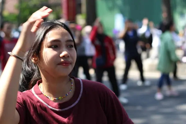 stock image happy asian young woman dancing at summer festival, cheerful asian woman having fun at music festival with the crowd