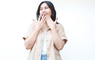 Şok olmuş Asyalı kadın beyaz arka planda izole edilmiş günlük kahverengi kıyafetler giyiyor.