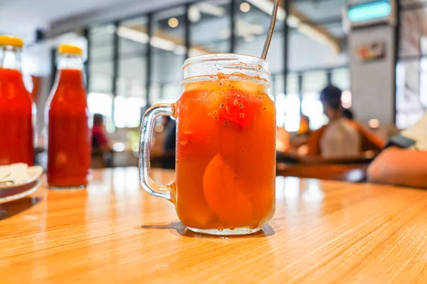 stock image iced fruit tea, with pieces of fruit in a glass cup