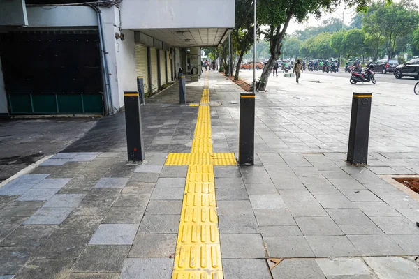 Pedestrian paths, Braille block in tactile paving for the blind handicapped in tiled pathways, paths for the blind.