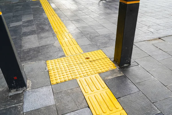 Pedestrian paths, Braille block in tactile paving for the blind handicapped in tiled pathways, paths for the blind.