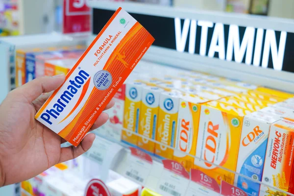 stock image Jakarta, Indonesia, february 16, 2022: hand is holding ester c, enervon c, pharmaton, vitamin c effervescent tablets to increase endurance, with a background in medicine products