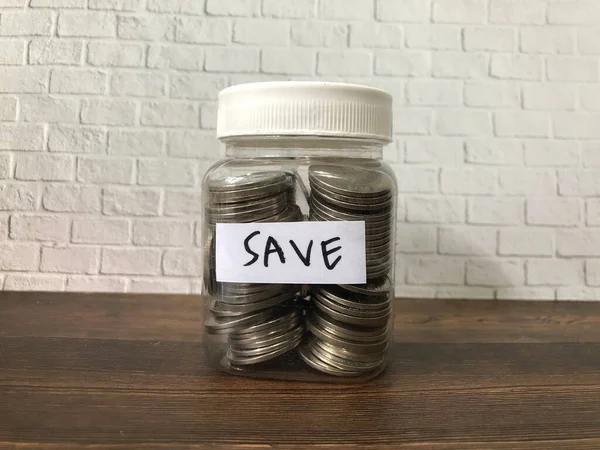 Jar with coins and save label