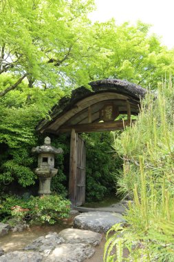 Fresh green and the entrance gate in Okochi-sanso Garden, Kyoto, Japan clipart