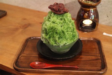 Matcha Kakigori (Japanese shaved ice dessert) with azuki in Kyoto, Japan clipart