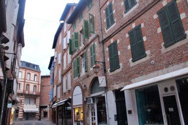 Old town with red brick and tiles of Albi in France clipart