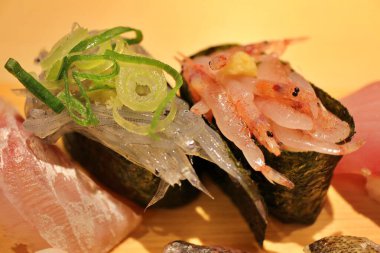 Japanese cuisine: raw whitebait and sakura shrimp nigiri-zushi in Numazu, Japan clipart