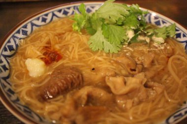 Taiwanese cuisine: misua noodles with pork intestines and coriander clipart