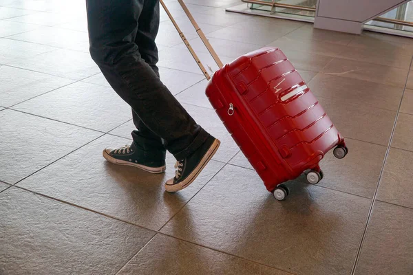 Homem Caminhando Aeroporto Carregando Uma Mala Vermelha — Fotografia de Stock