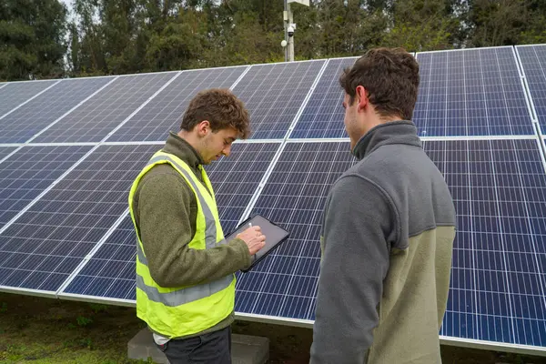 Two young individuals engaged in a conversation about solar panels.