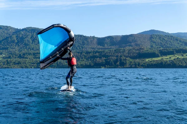 Stock image Young man learning how to wingfoil in a summer day