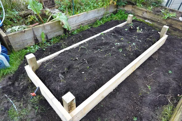 fixing raised wooden bed. building raised beds in the vegetable garden with wood.